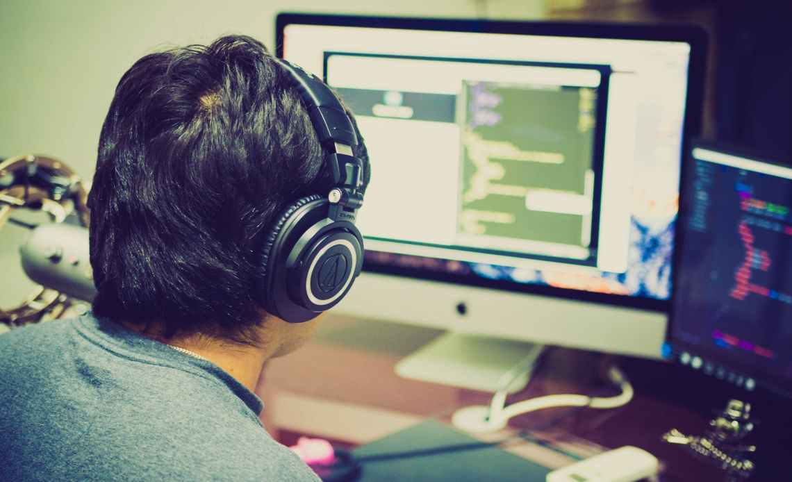 selective focus photography of man facing computer